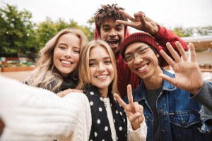 Happy teen friends taking a selfie together