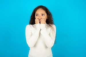 Woman covering her mouth to hide gaps between her teeth