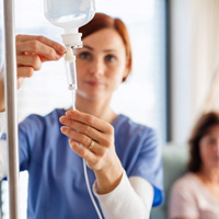 Dental team member preparing an IV drip