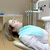 Relaxed dental patient reclining in treatment chair