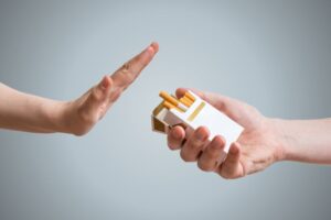 Person firmly declining the offer of a cigarette